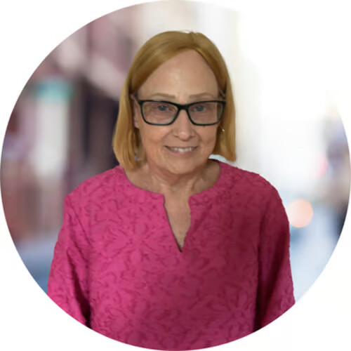 Diane Bidwell, LSCSW — smiling, wearing glasses and a pink top